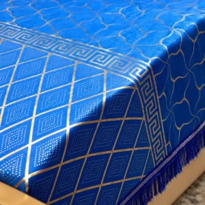 close up of the navy blue velvet bedsheet fabric and gold print