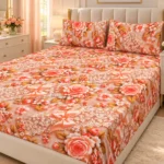 Peach Lace 3D Bedsheet with two pillow covers on an ivory padded headboard bed