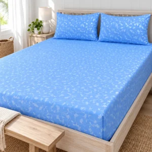 Sky Blue Vine Pure Cotton Bed Sheet with two pillow covers on a whitewashed wooden bed with a bench at the foot